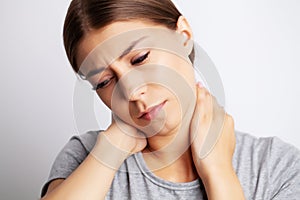 Exhausted young woman suffering from severe neck pain