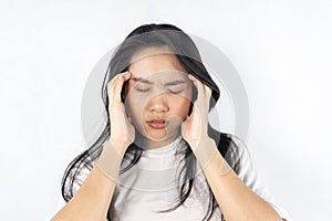 Exhausted young woman touching her head with eyes closed. Female exchange worker suffering from unbearable headache