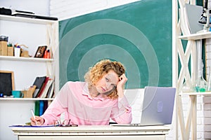 Exhausting lesson. Woman tired in school classroom. Teacher exhausted after hard working day. School pedagogue stressful