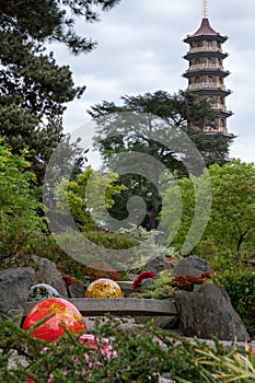 Exhibit entitled `Niijima Floats` by glass artist Dale Chihuly at Kew Gardens, London UK. Pagoda in background.