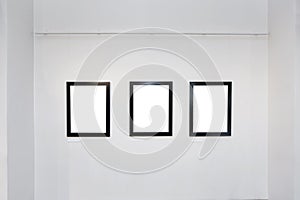 Exhibition gallery interior with empty frames on wall