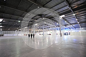 Exhibition hall of Kiev Expo center, blurred stands and people walking on a background. Kiev, Ukraine