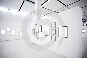 Exhibition with many empty frames on white walls