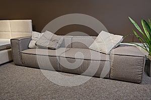 Exhibition of upholstered furniture with different quality and texture fabrics in the showroom- sofas, beds, settees. Beautiful photo