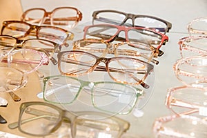Exhibitor of glasses consisting of shelves of fashionable glasses shown on a wall at the optical shop. optics, health