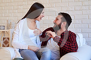 Exhilarated couple smiling at each other isolated in the living