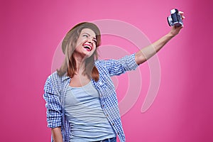 Exhilarated woman smiling while making selfie photo