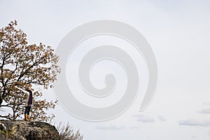 Exhilarated woman standing on rocks