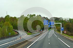 Exit from the road, interchange on the motorway in the forest in France in the spring