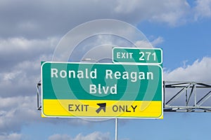 exit Ronald Reagan boulevard from interstae 35 with traffic in afternoon sun