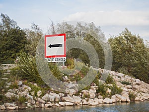 Exit sign for canoes on the river. \