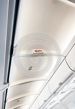 Exit sign on ceiling on aircraft with lights