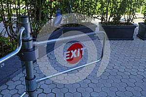 Exit sign on a fence close-up. Building exterior. Metal fence. Door close-up,