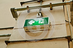 Exit sign fire alarm on brick wall