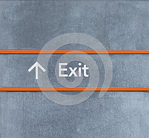 Exit sign icon and arrow on the wall