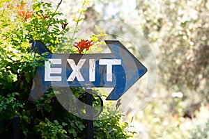 Exit sign metal plate in the shape of an arrow outdoors