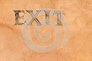Exit sign on a stucco wall