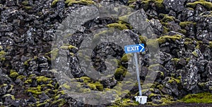 Exit signal at volcano lava rock and moss