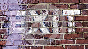 EXIT stenciled on a brick wall