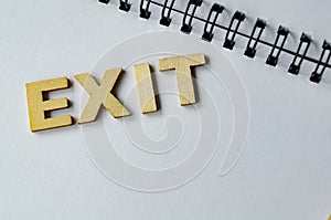 EXIT text on white notepad.