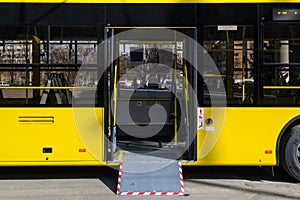Exit from yellow citybus with a ramp photo