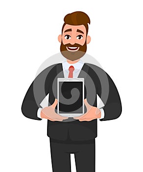 Exited young bearded business man showing/holding blank screen of new digital tablet computer in hands. Modern, latest trend.