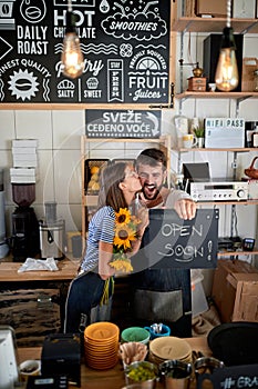Exited young couple having fun in their own cafe before opening. enthusiastic, excitement, joy, startup, business concept