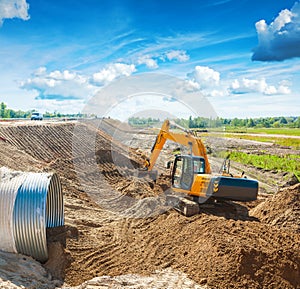 Exkavator working on construction site near the road