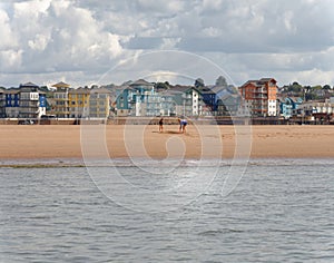 Exmouth, devon: playing on the beach. clouds