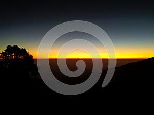 Exotic 180-degree shot of orange winter line with mountain silhouettes in Mussoorie, Uttarakhand, India. Stunning winter scenery