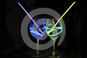 Exotic alcoholic transparent beverages in wine glass with dark background for party celebration, new year, bar and christmas with