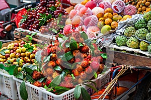 Exotic Asian fruit on local market. Asian cuisine concept.Fresh rambutans,Kiwano melon,kepundung, lemon