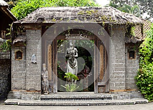 Exotic Bali house gate with sculptures, traditional patterns and foliage