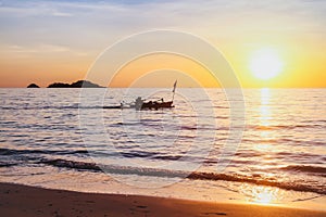 Exotic beach at sunset with silhouette of fisherman boat, inspiring tropical landscape