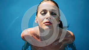 Exotic beautiful woman sunbathing and swimming