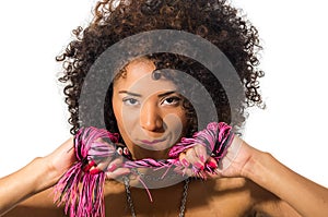 Exotic beautiful young girl with dark curly hair holding whip posing