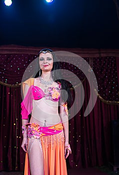 Exotic Belly Dancer Standing on Stage Smiling