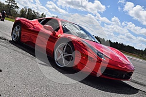 Red Ferrari with mirror paint on a track in Florida