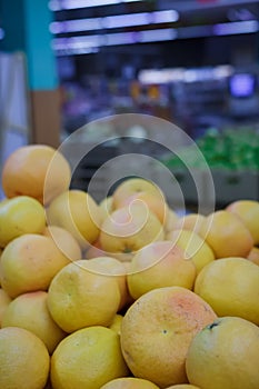 Exotic citrus fruit in supermarket or grocery store, shop. Heap of oranges on counter
