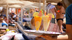 Exotic Cocktails in a Glass with a Straw on a Tray on the Background of the Sea. Egypt.