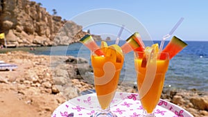 Exotic Cocktails in a Glass with a Straw on a Tray on the Background of the Sea. Egypt.