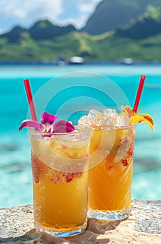 Exotic cocktails with tropical fruits in glasses with tropical coastline as a backdrop.