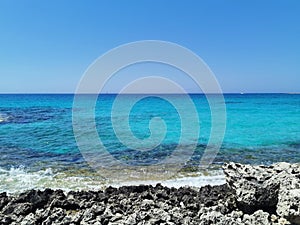 Exotic crystal clear blue water and a white rocky shore in a summer day , Cyprus