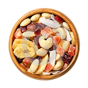 Exotic dried fruit mix with nuts, trail mix and snack food in wooden bowl