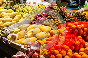Exotic fresh Thai fruits at the night market in Pattaya Thailand: dragonfruit, passion fruit, mango, tangerines, oranges