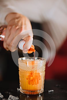 Exotic fruit cocktail in glass isolated on blurred restaurant background.