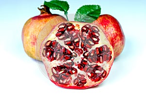 Large pomegranate cut in half with a clear view of the inside of the fruit with stones lying photo