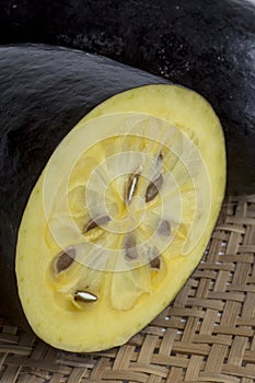 The exotic fruit jambolan sliced on wicker sieve photo