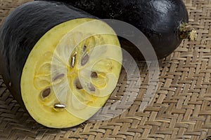 The exotic fruit jambolan sliced on wicker sieve photo