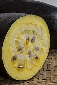 The exotic fruit jambolan sliced on wicker sieve photo